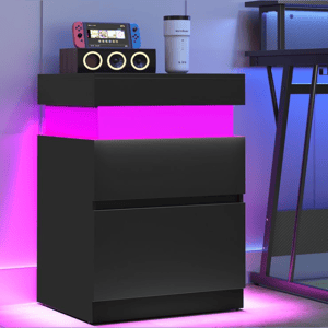 A black cabinet with pink LED lights displays a gaming console with red and blue controllers, a speaker with circular elements, and a white Ember travel mug.