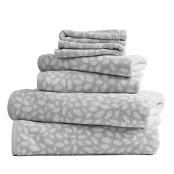 A stack of grey towels with a white floral pattern, including bath towels, hand towels, and washcloths.