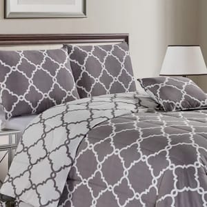 A gray and white patterned bedding set, consisting of a comforter and pillowcases.
