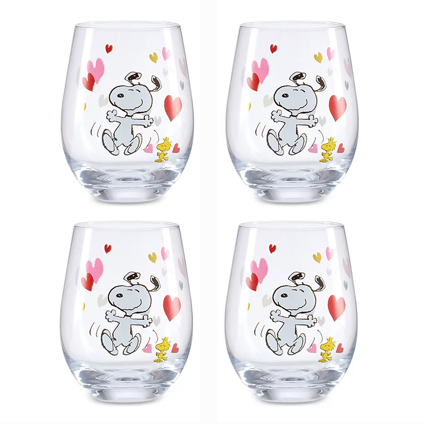 Set of four Lenox glass tumblers featuring Snoopy and Woodstock with colorful hearts. The tumblers have a playful design, highlighting the characters in a joyful pose with pink, red, and gold hearts.