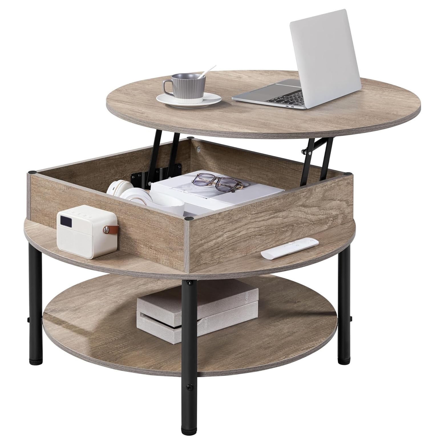 Round coffee table with a lift-top, featuring hidden storage under the tabletop and an additional lower shelf. Includes items like a laptop, cup, glasses, headphones, and a projector on or inside the table.