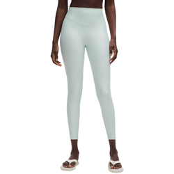 A person wearing light mint green high-waisted leggings and white sandals.