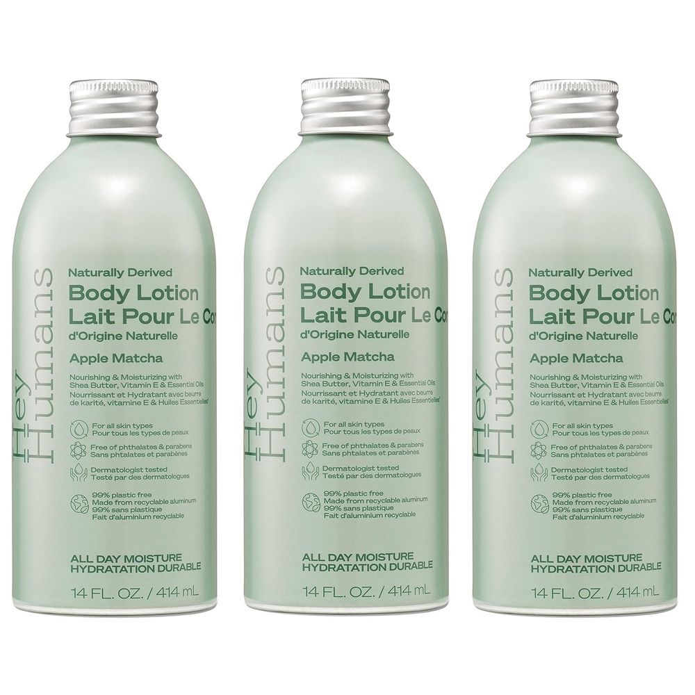 Three bottles of Hey Humans Apple Matcha Body Lotion, 14 fl. oz. each, are displayed. The lotion is naturally derived, suitable for all skin types, and free of phthalates and parabens. Made from recyclable aluminum.