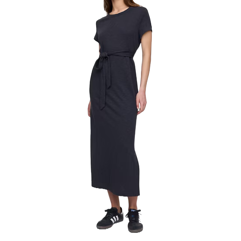 A black belted t-shirt midi dress featuring short sleeves, a round neckline, and a waist tie for a cinched look. Paired with casual black sneakers with white stripes.