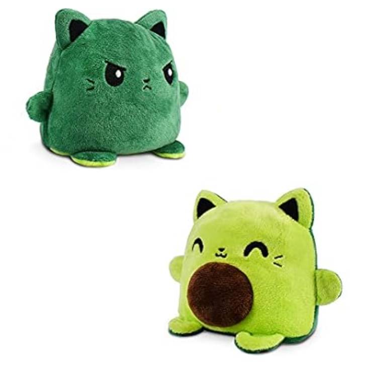Green plush toy with a reversible feature, displaying a happy expression on one side and an angry expression on the other.