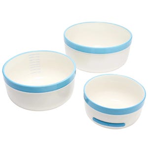 Three white bowls with blue rims, featuring different sizes; one has measurement markings inside.