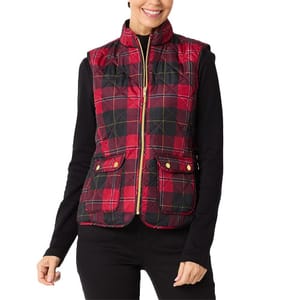 A red and black plaid quilted vest with a zipper closure and two front pockets, worn over a black long-sleeve top.