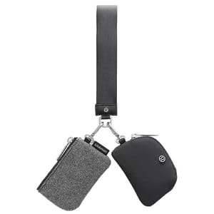 A dual-pouch keychain featuring one grey textured pouch and one black pouch connected by clips to a black loop strap, both branded with the Lululemon logo.