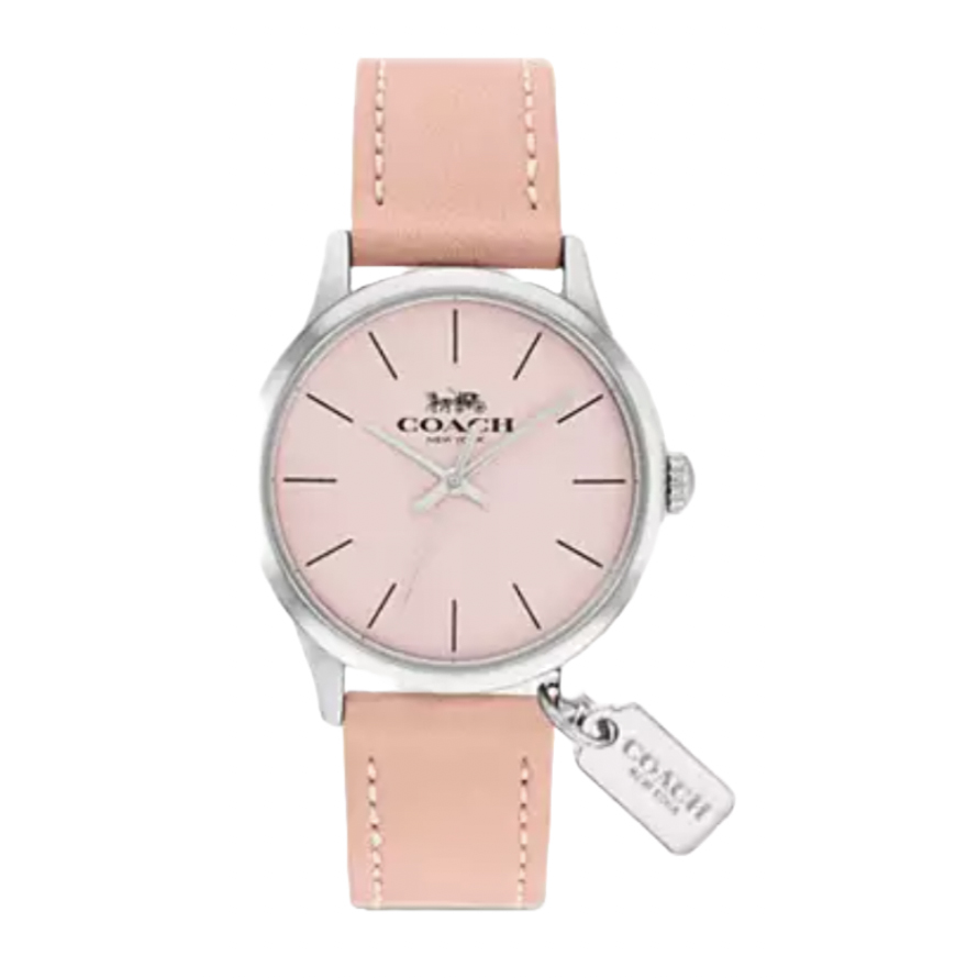 A Coach watch featuring a pink dial and silver case, complemented by a pink leather strap. It includes a small tag with the Coach logo attached to the watch.