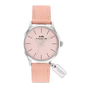 A Coach watch featuring a pink dial and silver case, complemented by a pink leather strap. It includes a small tag with the Coach logo attached to the watch.