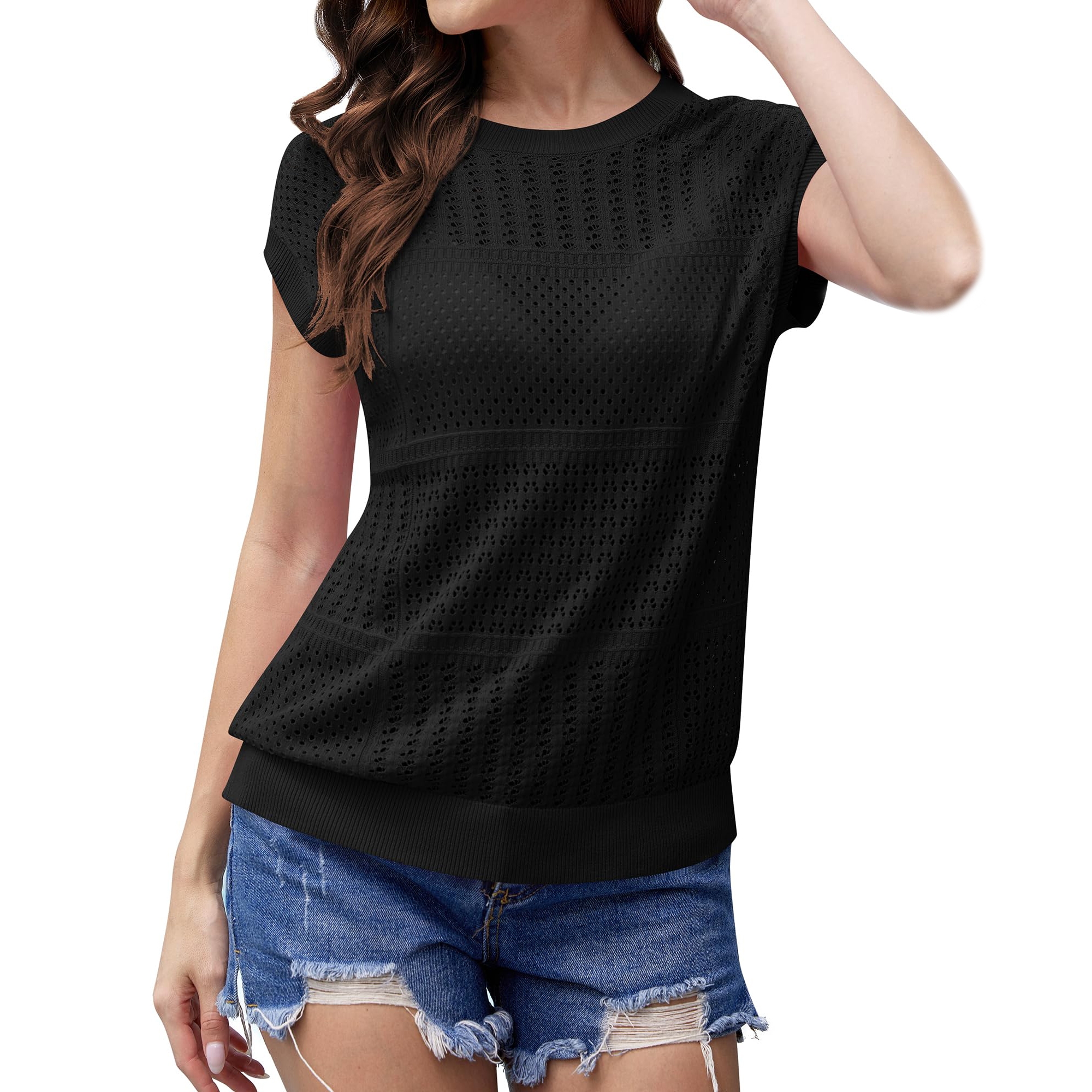 A woman is wearing a black, short-sleeve, perforated top with a round neckline, paired with distressed denim shorts.
