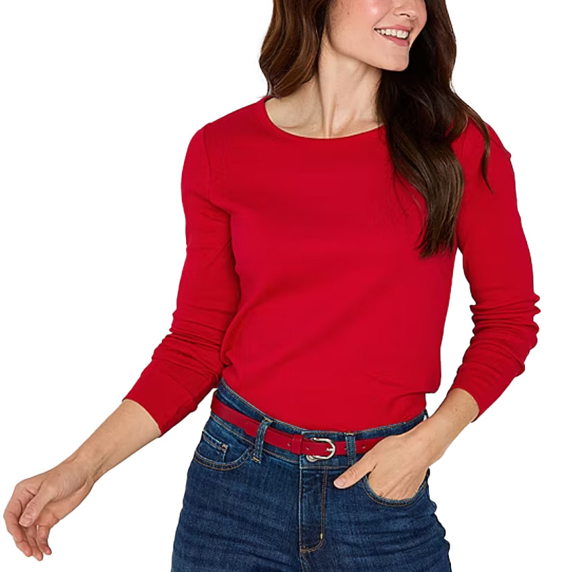 A woman wearing a red long-sleeve top and blue denim jeans with a red belt.