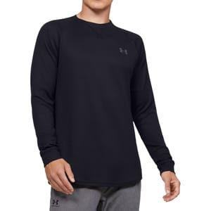 A long-sleeve black crewneck shirt by Under Armour with a waffle-texture fabric and the brand's logo on the upper chest.