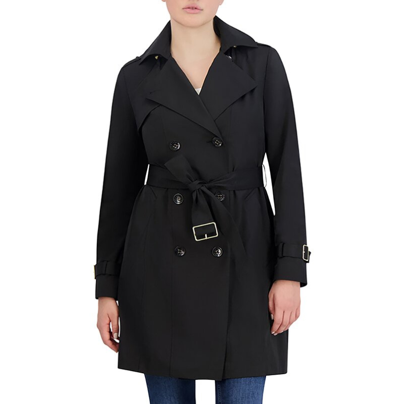 Classic double-breasted trench coat in black with a belted waist, buttoned cuffs, and notched lapels, worn over blue jeans.