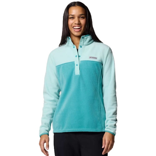 A person is wearing a two-tone teal and light blue fleece pullover with a button-up collar, featuring a small rectangular logo on the chest.