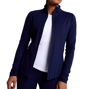 A woman is wearing a navy full-zip athletic jacket with a white top underneath.
