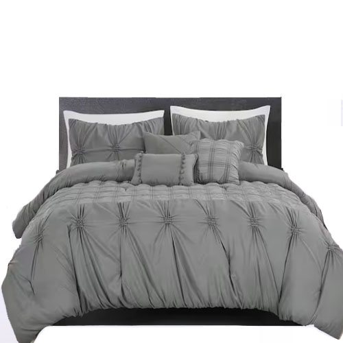 A gray bed comforter set with pillow shams and decorative cushions, featuring a pinched pleat design.