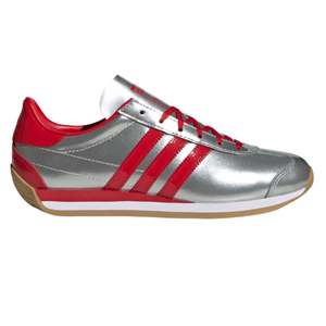 Athletic shoe with a silver body, red accents, and three red stripes on the side. It features a gum-colored sole and red laces.