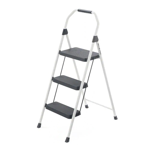 This is a three-step steel stool with a white frame, black steps featuring a non-slip texture, and a top handle for grip and balance.