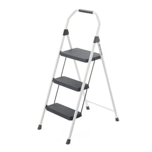 This is a three-step steel stool with a white frame, black steps featuring a non-slip texture, and a top handle for grip and balance.