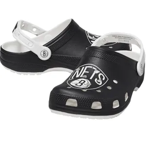 Black and white clogs featuring the Brooklyn Nets logo, with a white adjustable strap and perforated design.