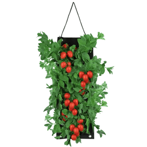 Hanging artificial tomato plant with lush green leaves and red tomatoes, featuring a black rectangular backing and suspended by a thin black string.
