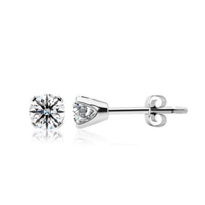 A pair of stud earrings featuring round, faceted gemstones set in a metal prong setting with butterfly backs.