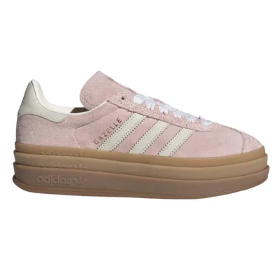 A pink Adidas Gazelle sneaker featuring white stripes, a suede finish, and a thick gum sole with Adidas branding.