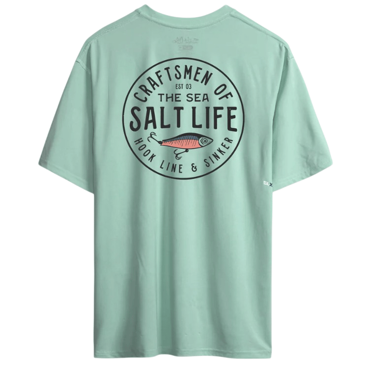 Mint green T-shirt featuring a circular design with the text \“Craftsmen of the Sea, Salt Life, Hook Line & Sinker\“ and an illustration of a fish.