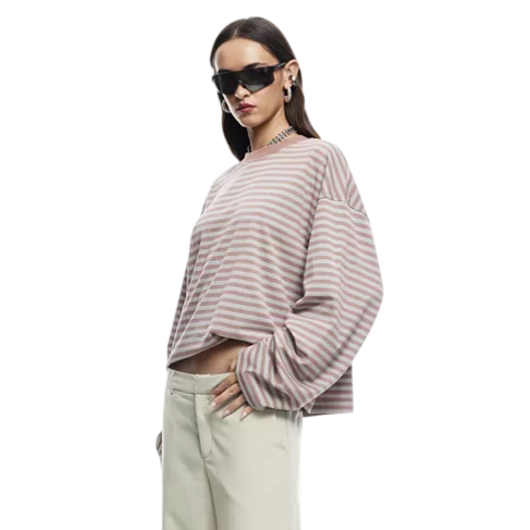 A person is wearing a striped long-sleeve top, cream-colored knee-length shorts, black pointed-toe shoes, dark sunglasses, and hoop earrings.