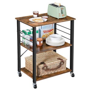 A kitchen trolley with three shelves holds a toaster, jar of jam, toast, cereal boxes, plates, and a wicker basket. It's on wheels for easy mobility.