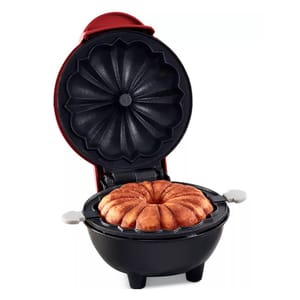 The Dash Mini Bundt Cake Maker is a compact appliance designed to bake small bundt cakes. It features a red exterior, clamshell design, and a non-stick floral-patterned mold for creating intricately shaped cakes.
