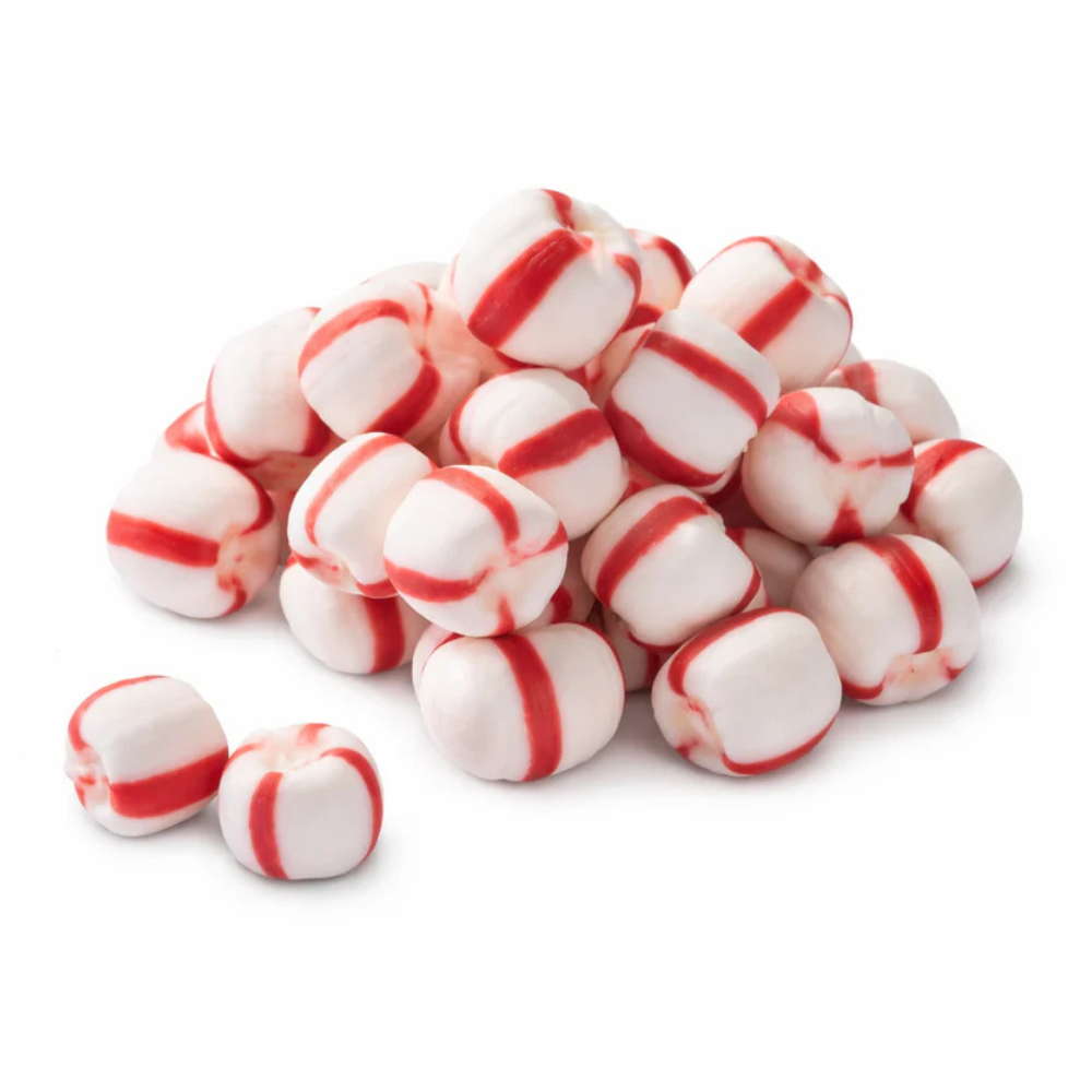 A pile of white and red-striped peppermint candies, showing their distinct cylindrical shape and color pattern.