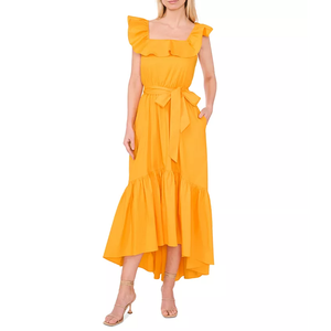 A woman is dressed in a sleeveless, ruffled, high-low hem, bright yellow dress with a tied waist, complemented by strappy beige heels.