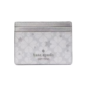 Kate Spade New York Spade Star Toss Small Slim Card Holder features a silver metallic design with floral and star motifs. It has multiple card slots and a stylish, minimalist appearance.