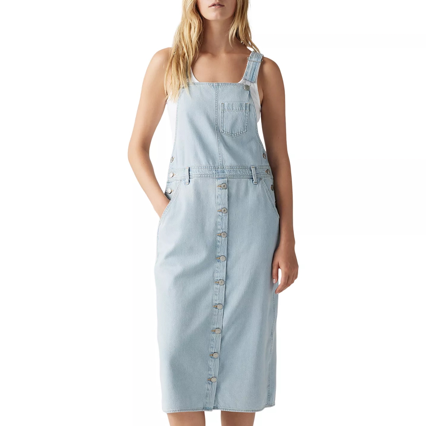 Light blue denim pinafore dress with a front button closure and side pockets, featuring adjustable straps and a chest pocket.