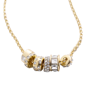 A gold chain necklace featuring multiple gold beads adorned with various clear crystals, giving a shimmering and elegant appearance.