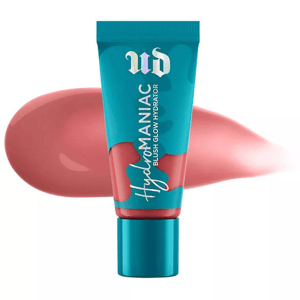 A teal tube with pink accents contains Urban Decay's Dewy Liquid Blush, shown next to a swatch of its pink creamy content.