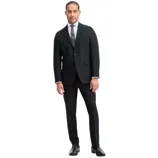 A man is wearing a tailored black suit with a white dress shirt, a patterned tie, and black dress shoes.