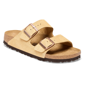 Birkenstock Arizona Sandals feature two beige suede straps with adjustable metal buckles, a cork-latex footbed, and an EVA sole for comfort and support.