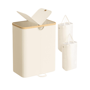 A beige laundry hamper with a wooden top edge and a hinged lid, accompanied by two detachable laundry bags with handles.