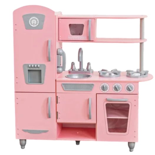 A pink miniature kitchen playset features components like a fridge, oven, stove, sink, microwave, and shelves, complete with silver accents.