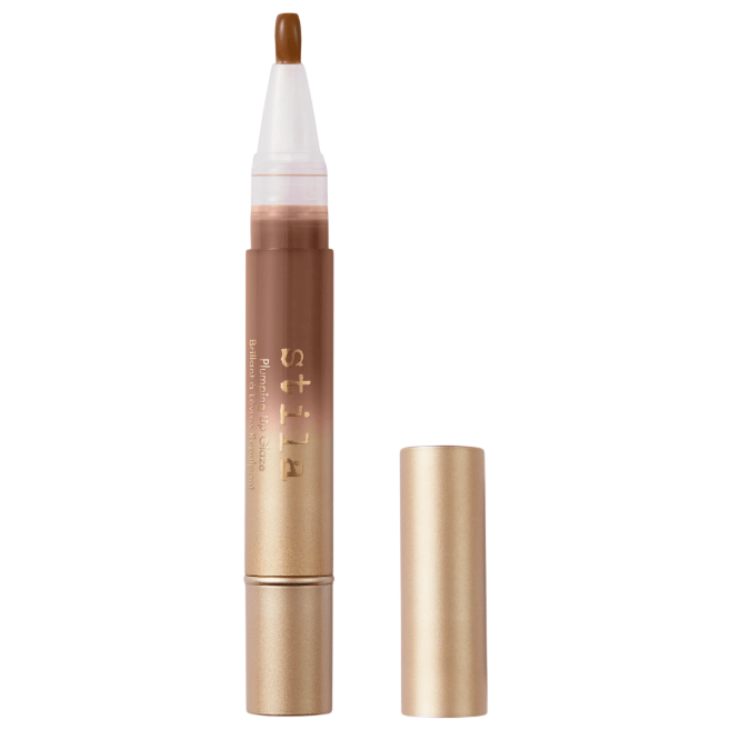 Stila Plumping Lip Glaze with a transparent applicator tip and a gold cap, featuring a sleek gold tube design.