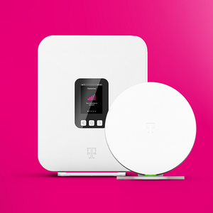 A white Wi-Fi router with a digital display showing connection status and a separate circular device, both featuring a logo, set against a pink background.