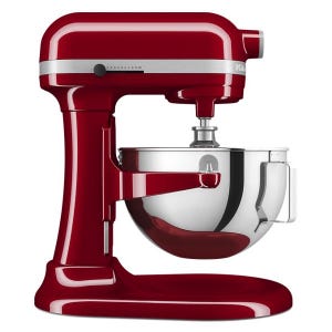 A red stand mixer with a stainless steel mixing bowl and speed settings on the side.