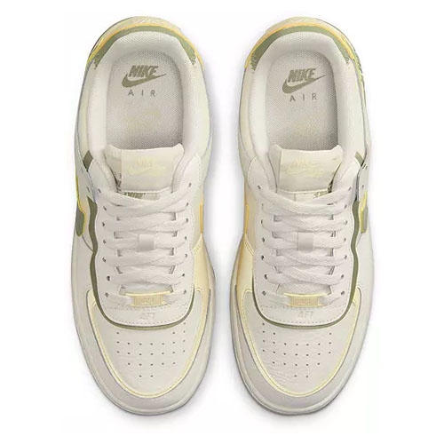 A pair of white Nike Air Force 1 sneakers with yellow accents, viewed from the top.