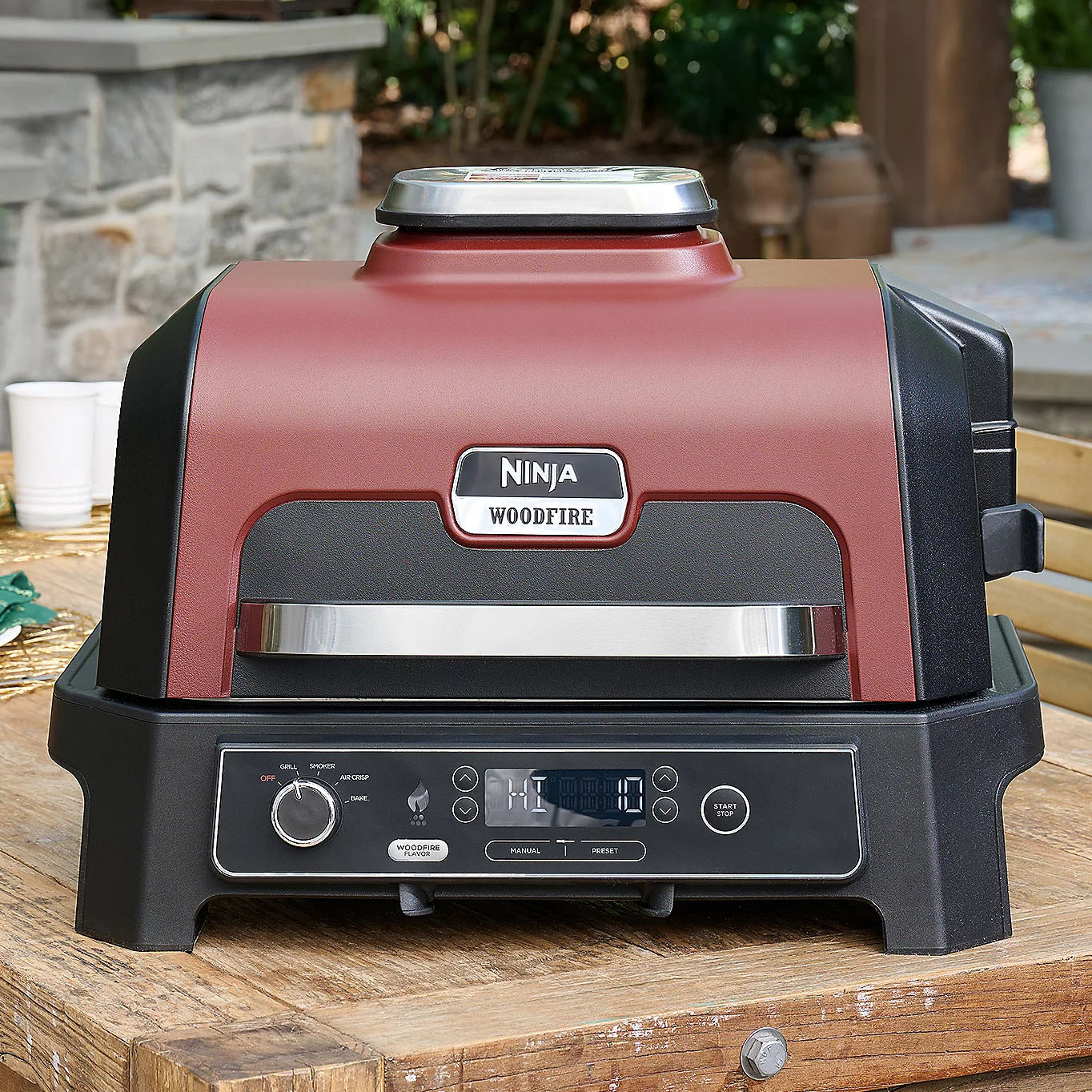 Ninja Woodfire outdoor electric grill with a woodfire flavor feature, digital controls, and a red and black design.