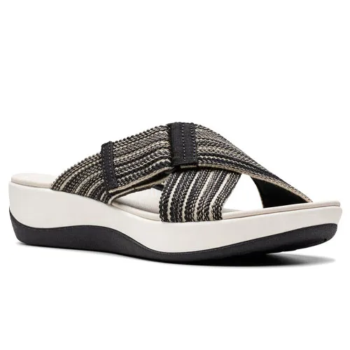 A sandal featuring a black and beige striped crisscross strap on a white platform sole with a wedge heel and black base.