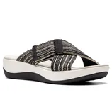 A sandal featuring a black and beige striped crisscross strap on a white platform sole with a wedge heel and black base.