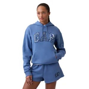 A person is wearing a blue GAP hoodie and matching shorts with the GAP logo in patterned letters.